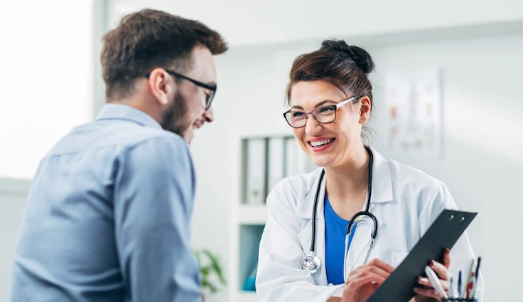 Physician consulting with patient in a warm office setting