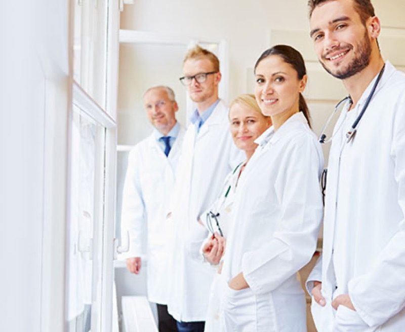 Group of physicians in white coats in a clinical setting