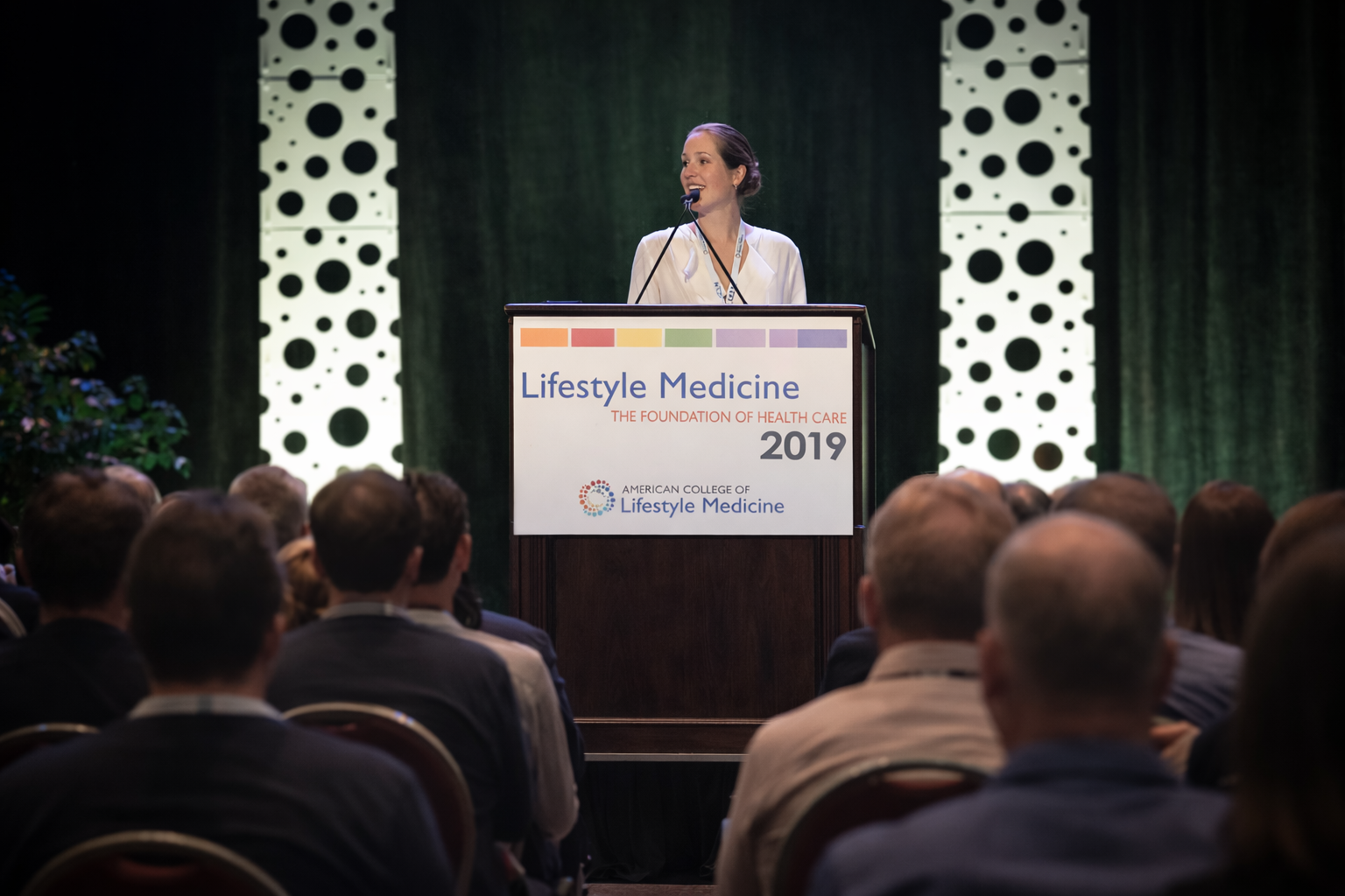 Dr. Motley presenting at the podium at the American College of Lifestyle Medicine 2019 conference